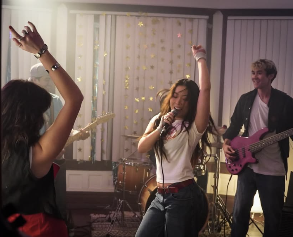 840 West - Singer performing with band, gold star decorations