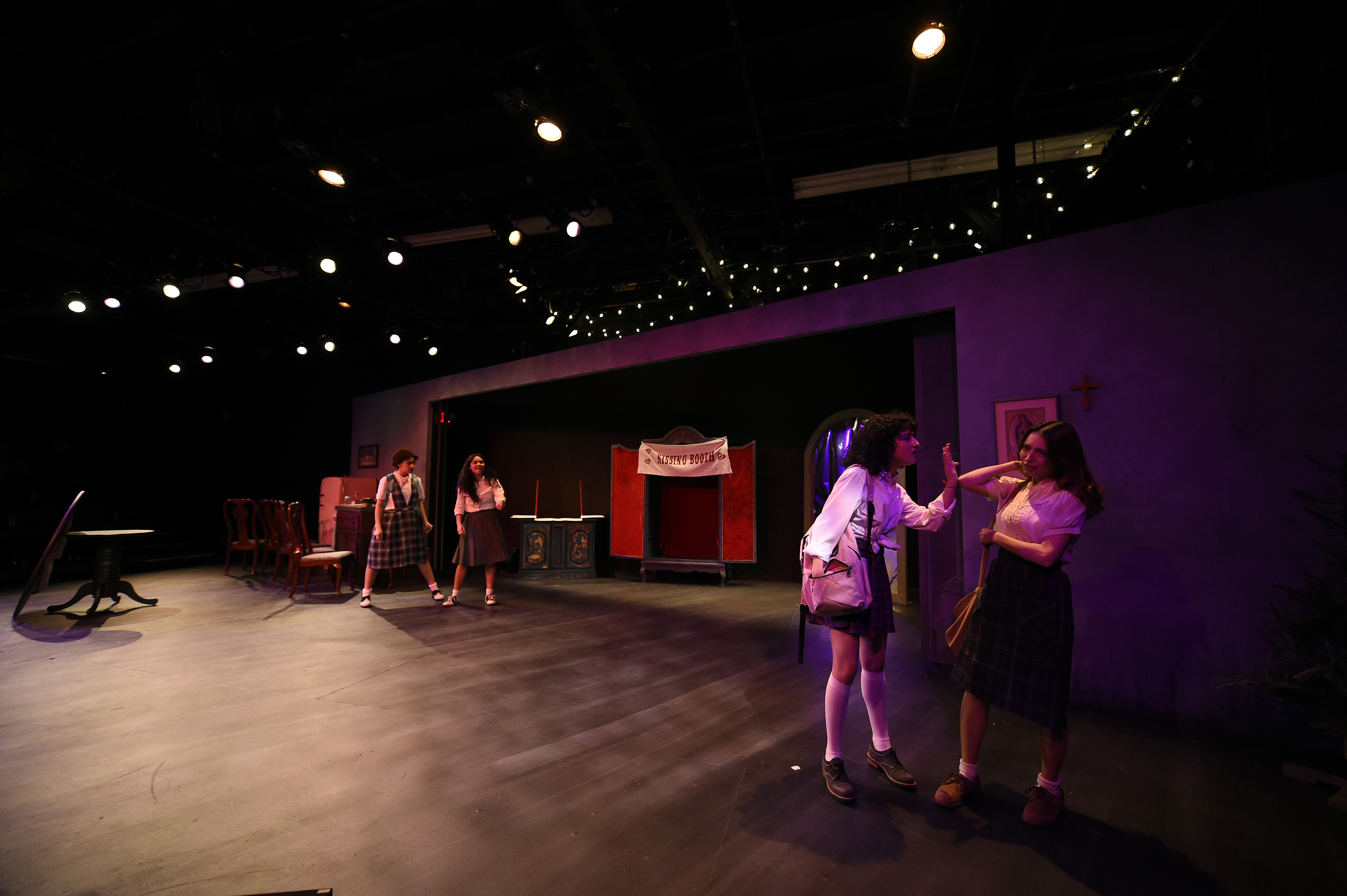 Broken Shells - Wide stage with kissing booth and purple walls
