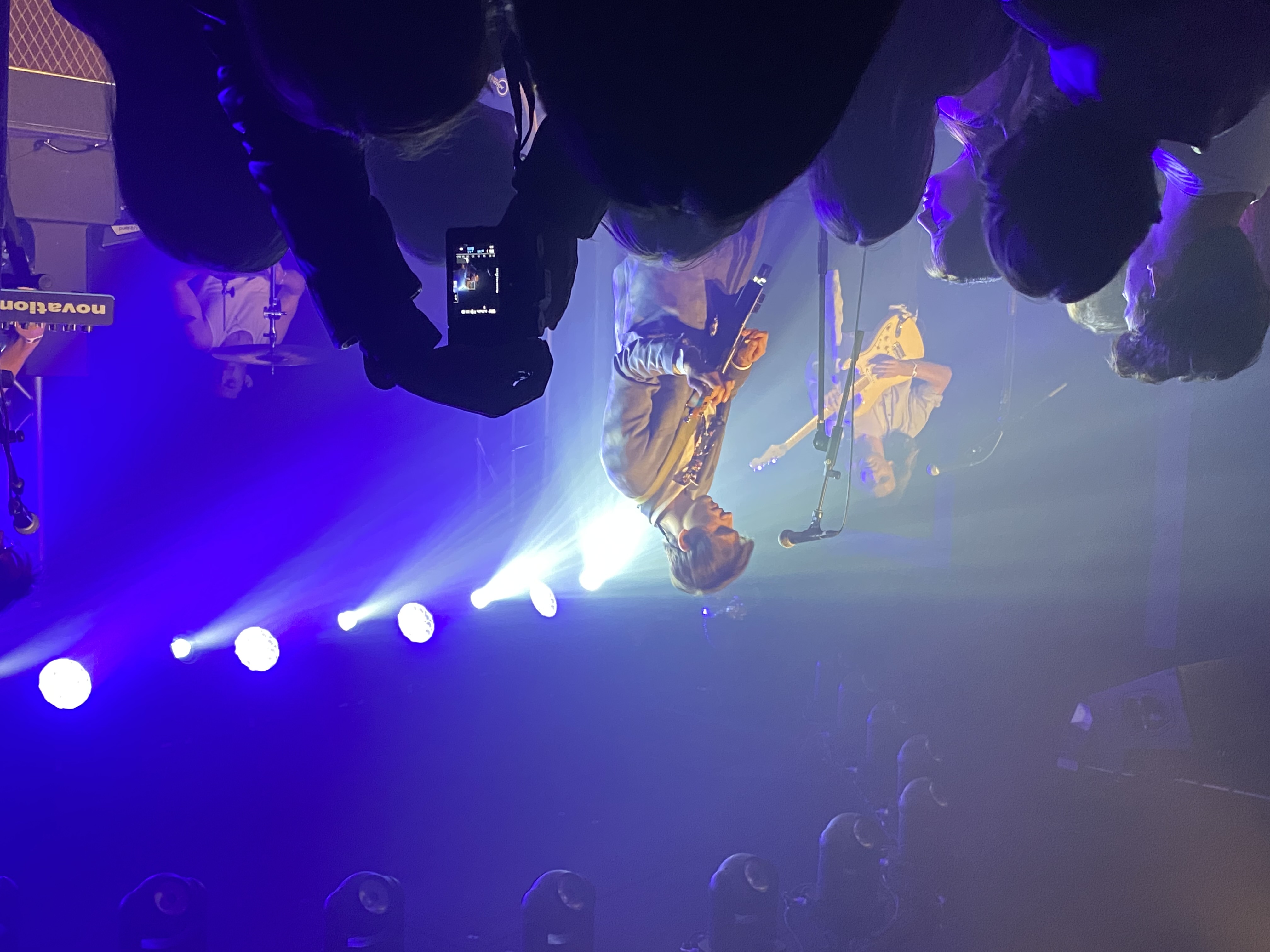 Indoor concert with blue and purple stage lighting