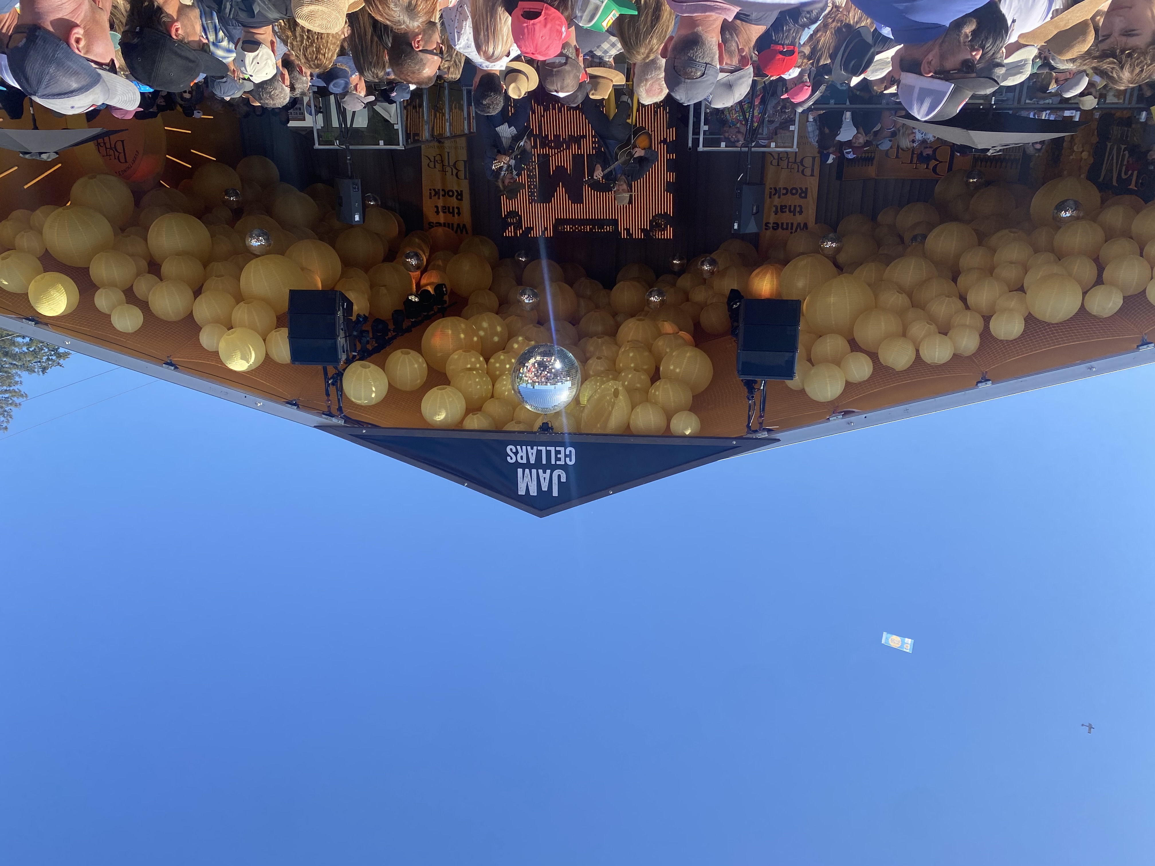 JaM Cellars stage with golden balloons and disco ball daytime performance