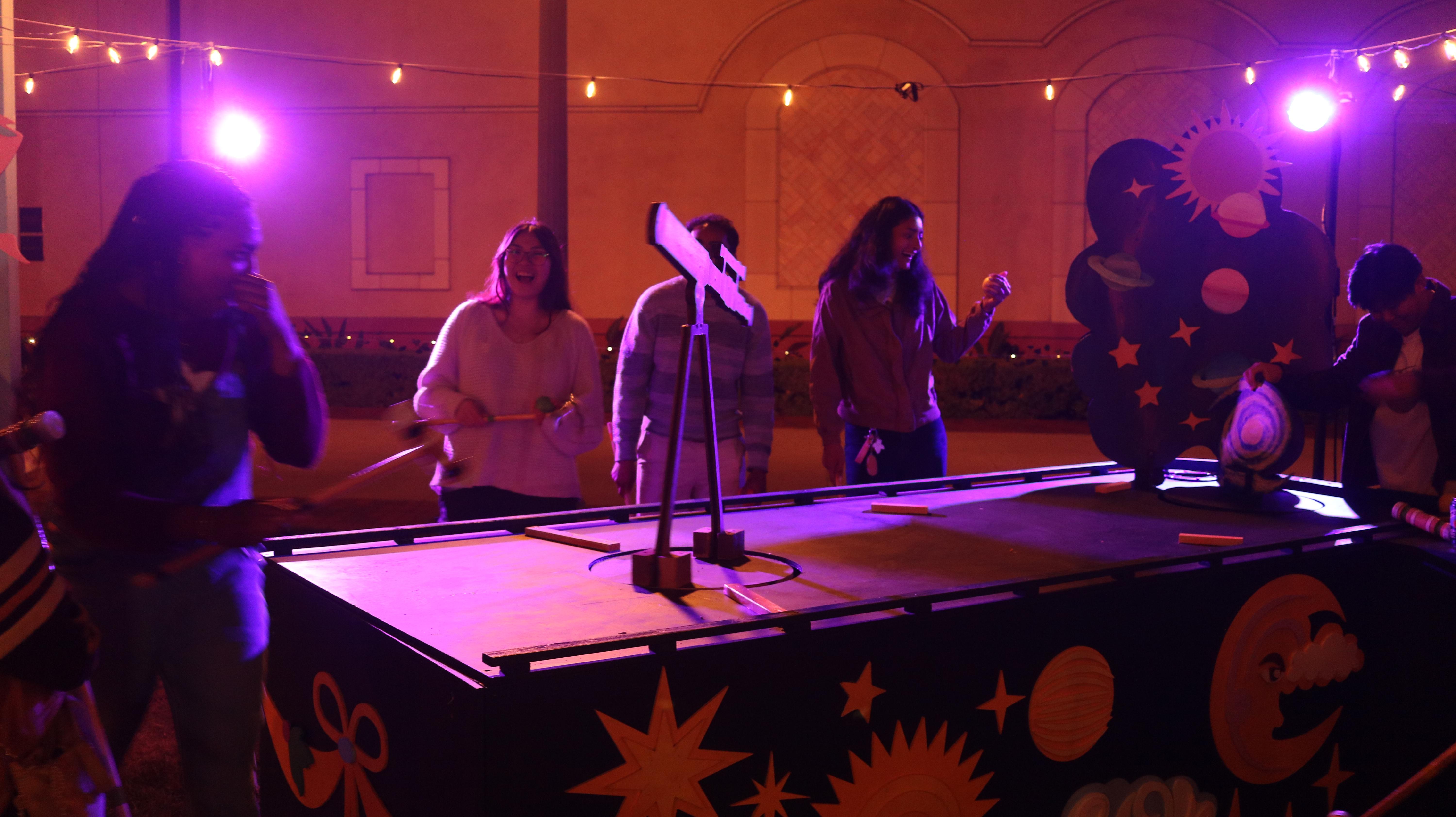 Fairy Fairways - Guests playing at celestial hole with purple lighting