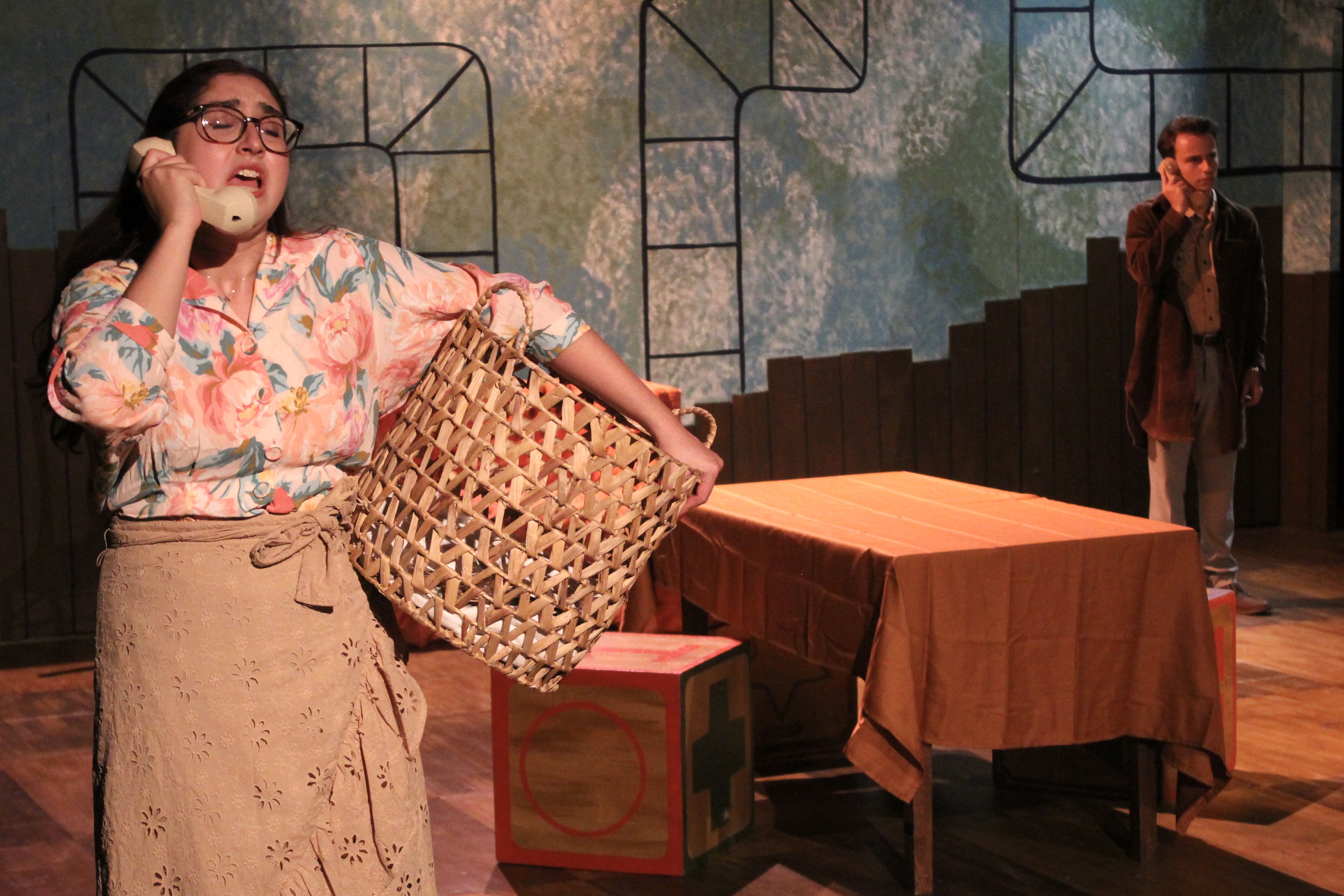 Falsettos - Woman on phone with basket, stained glass backdrop