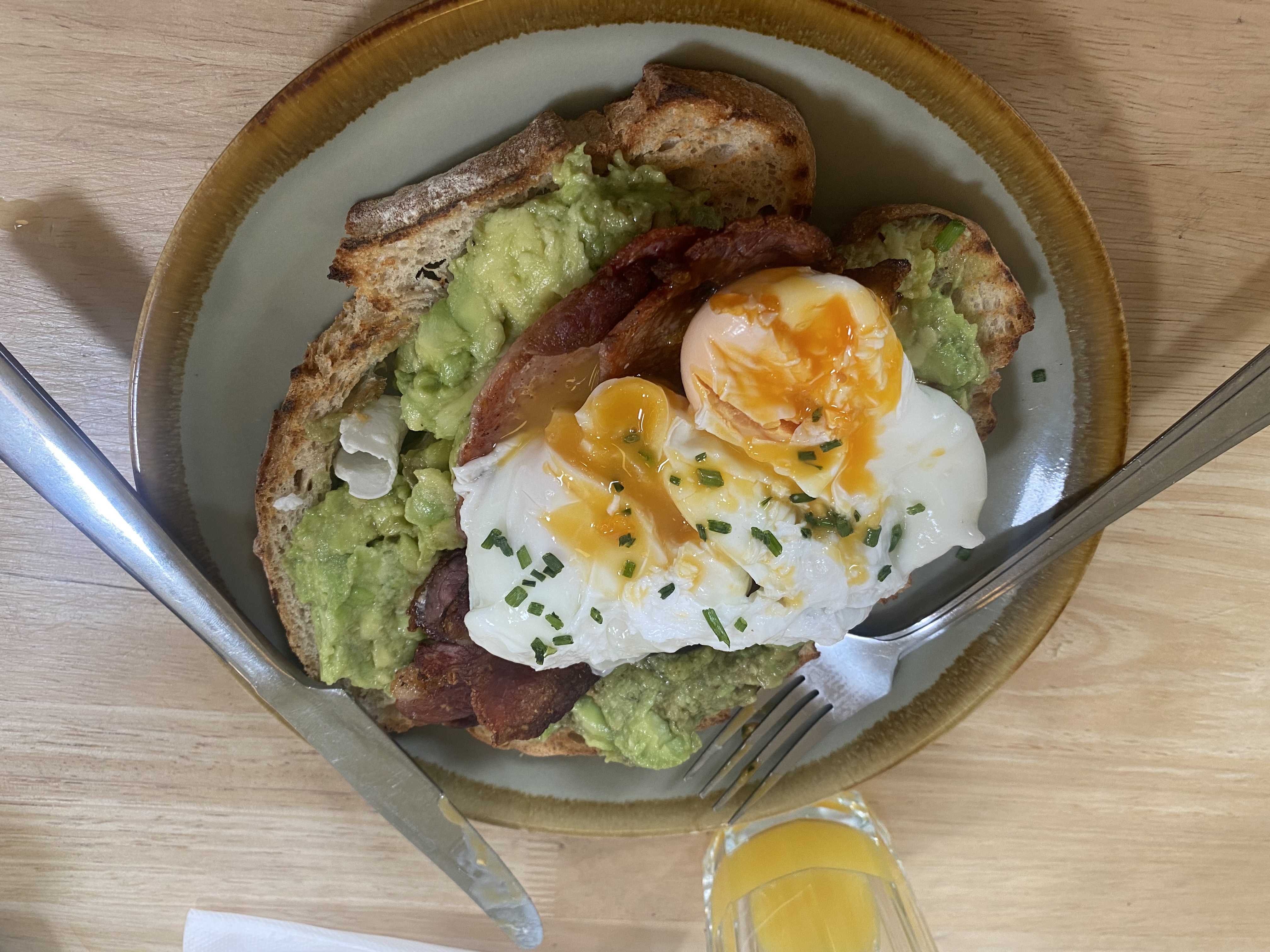 Avocado toast with poached eggs and bacon
