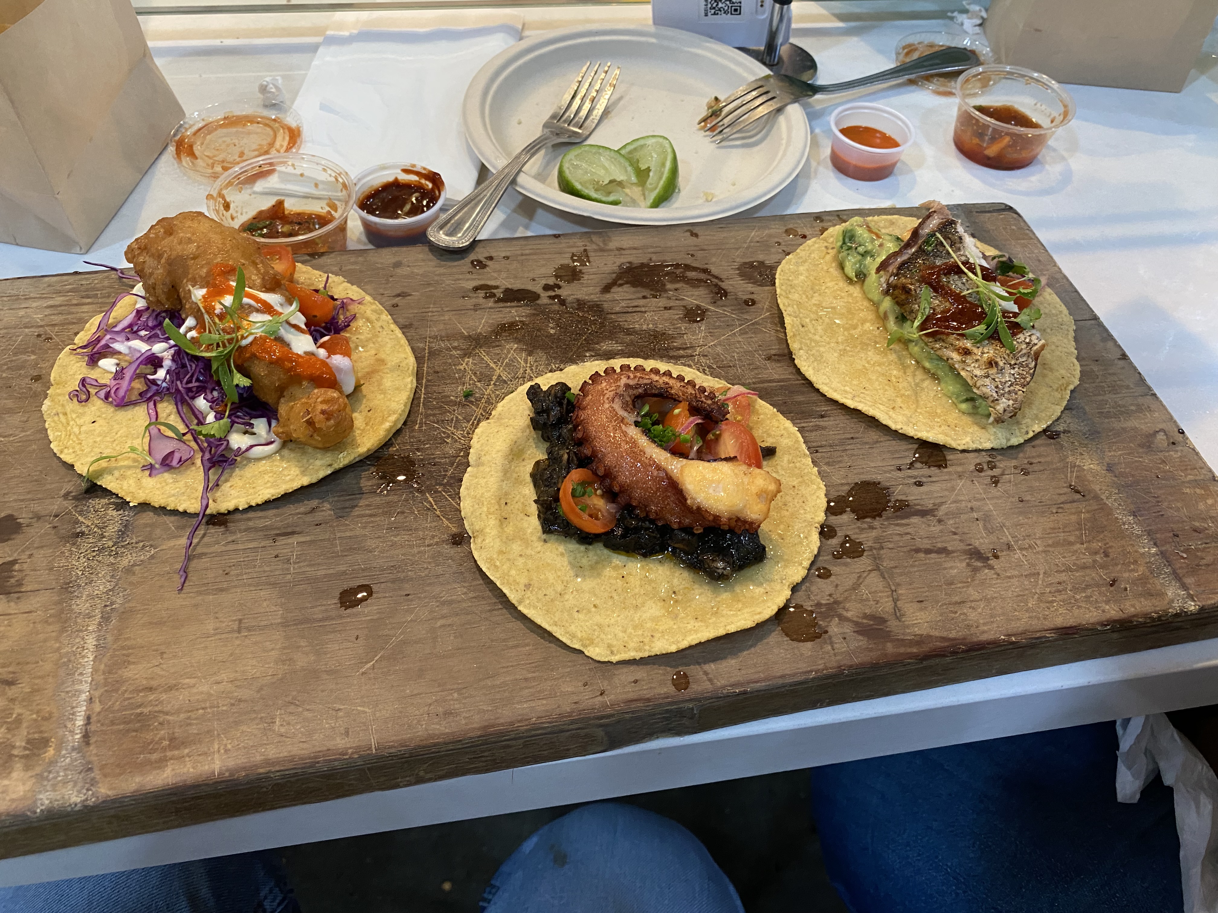 Gourmet seafood tacos with octopus on wooden board