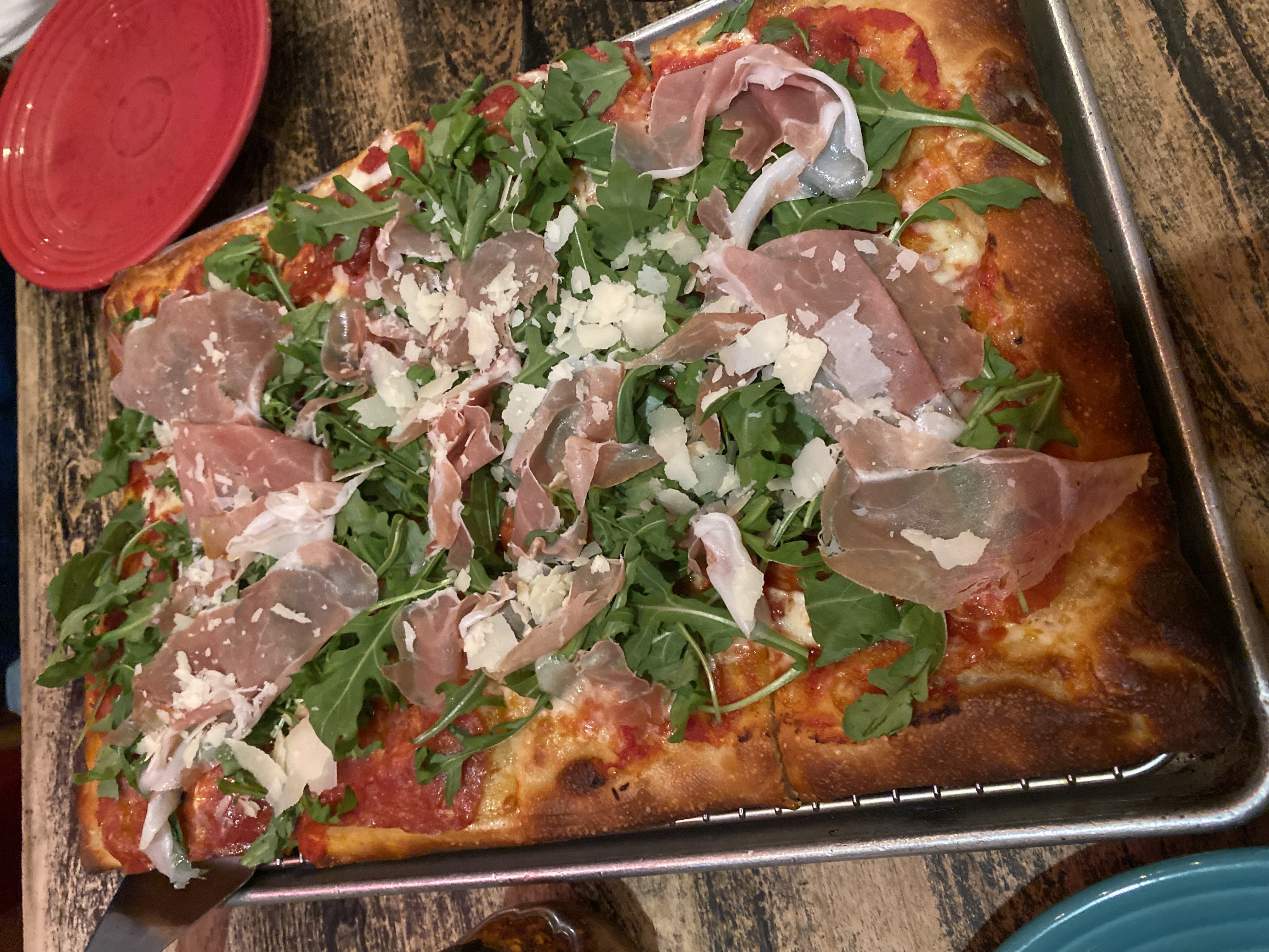Prosciutto and arugula pizza with parmesan