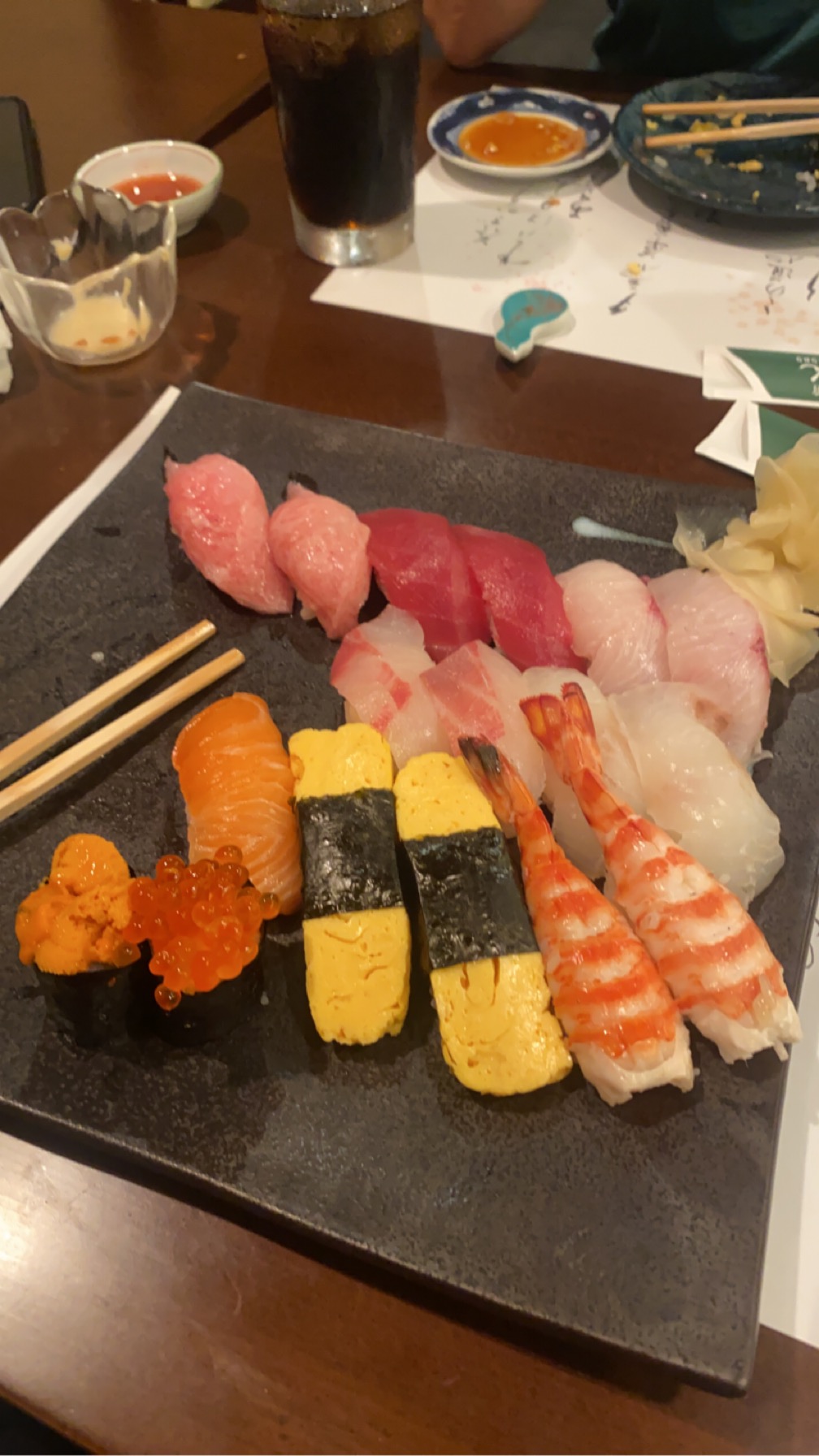 Sushi platter on slate with uni and ikura