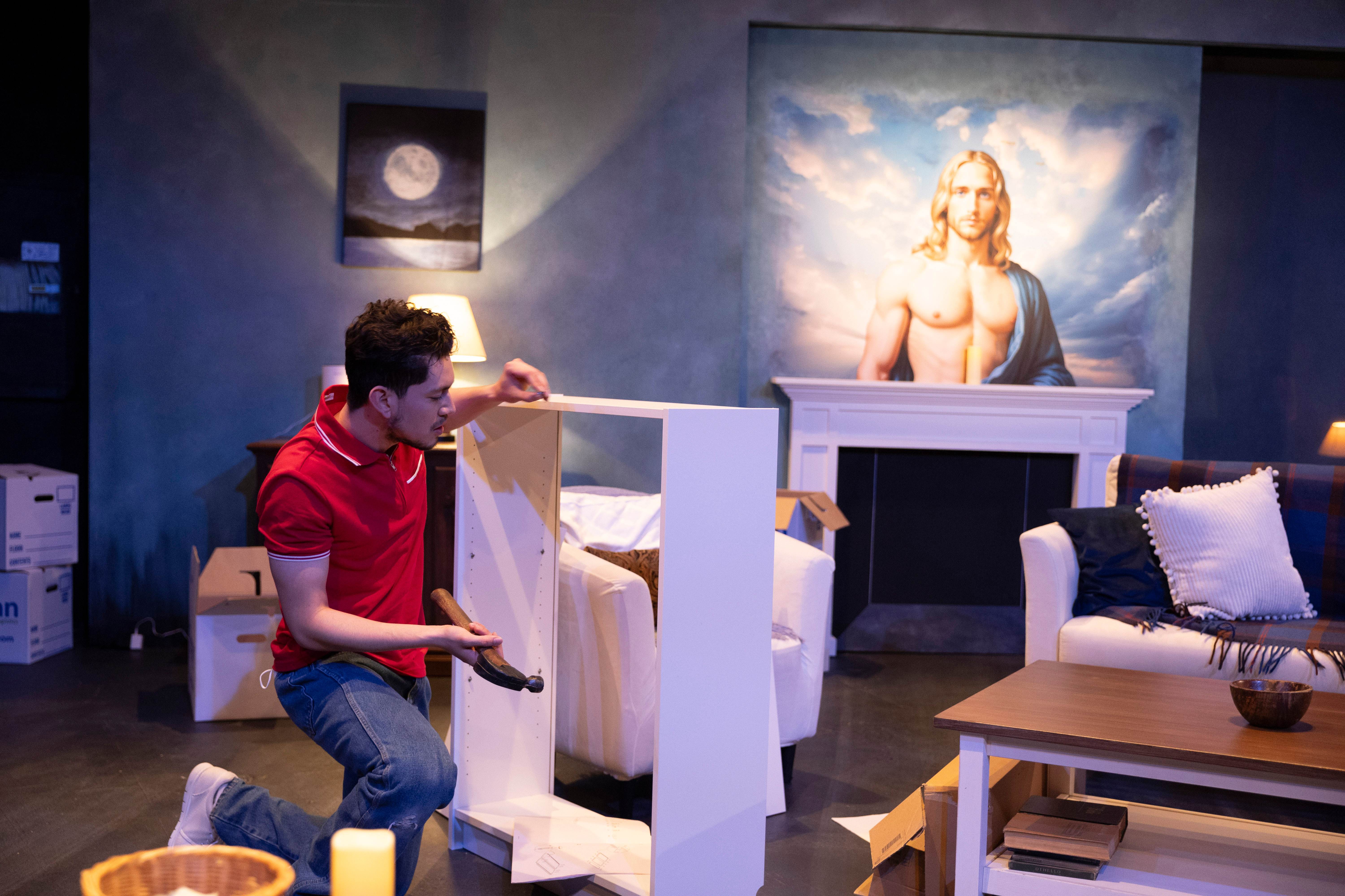 Between Fresno and Hell - Man assembling furniture with Jesus painting