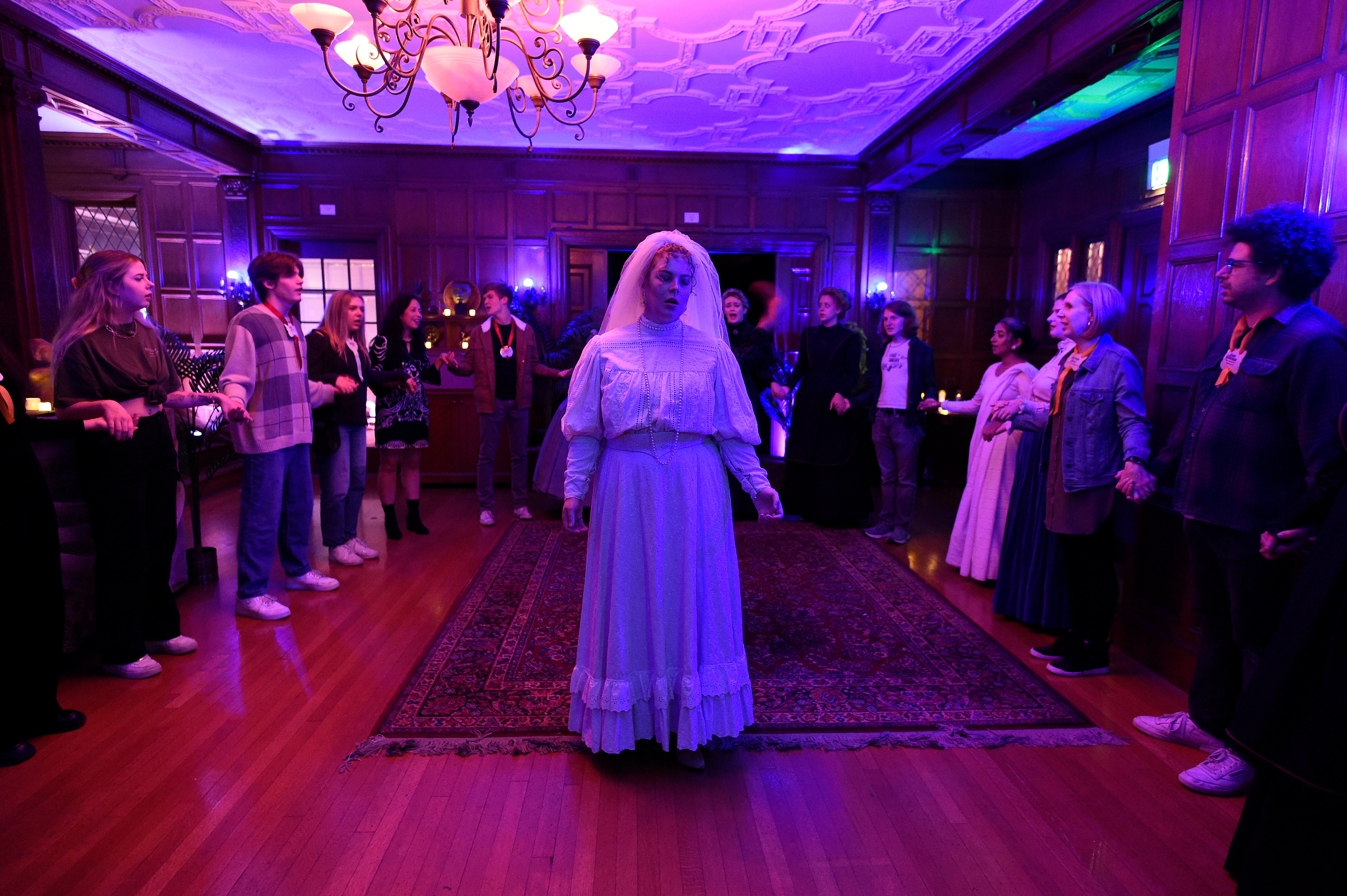 Ghosts of USC - Bride in white veil standing center of wood-paneled room
