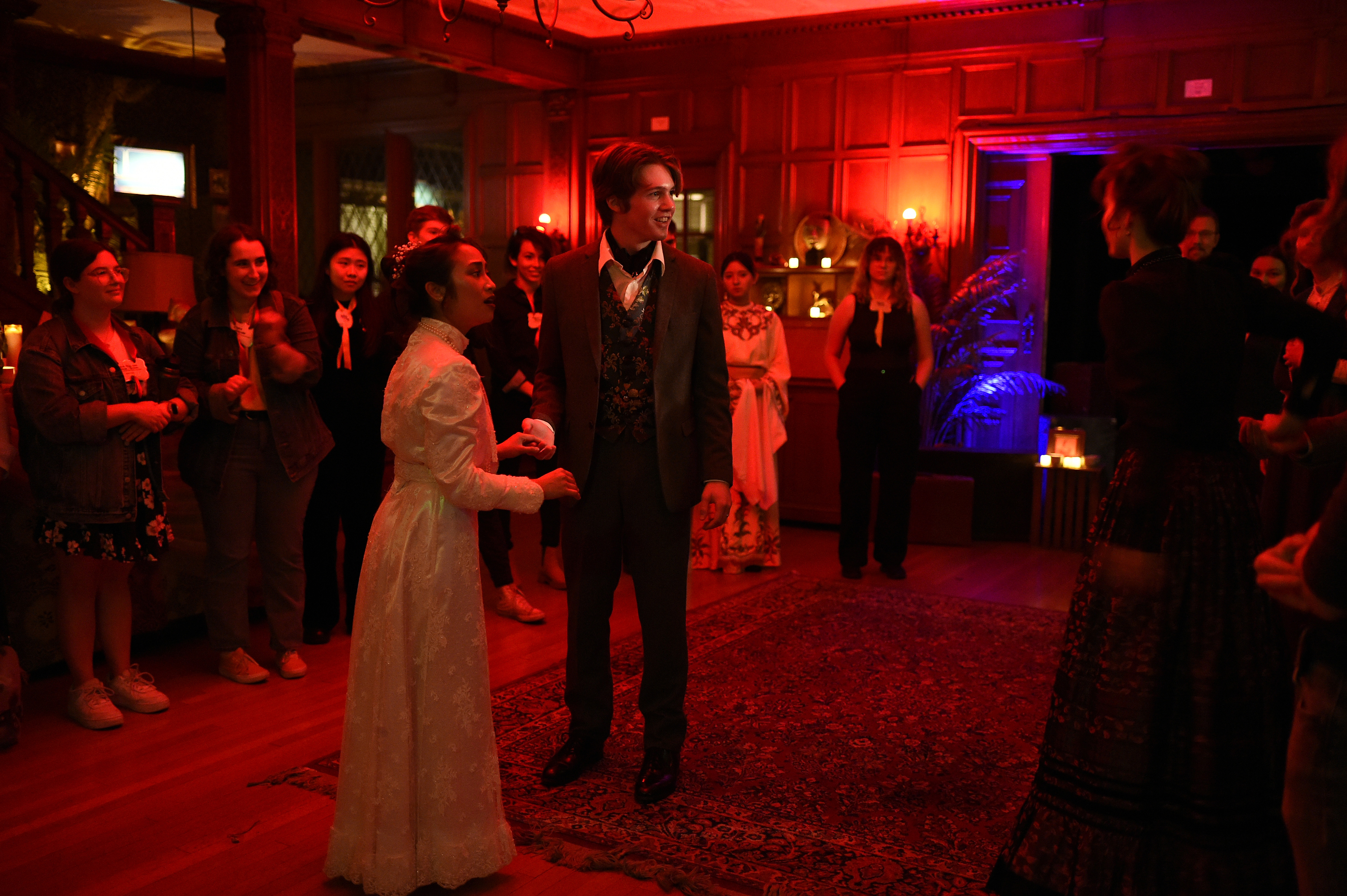 Ghosts of USC - Victorian couple dancing in red-lit wood-paneled room