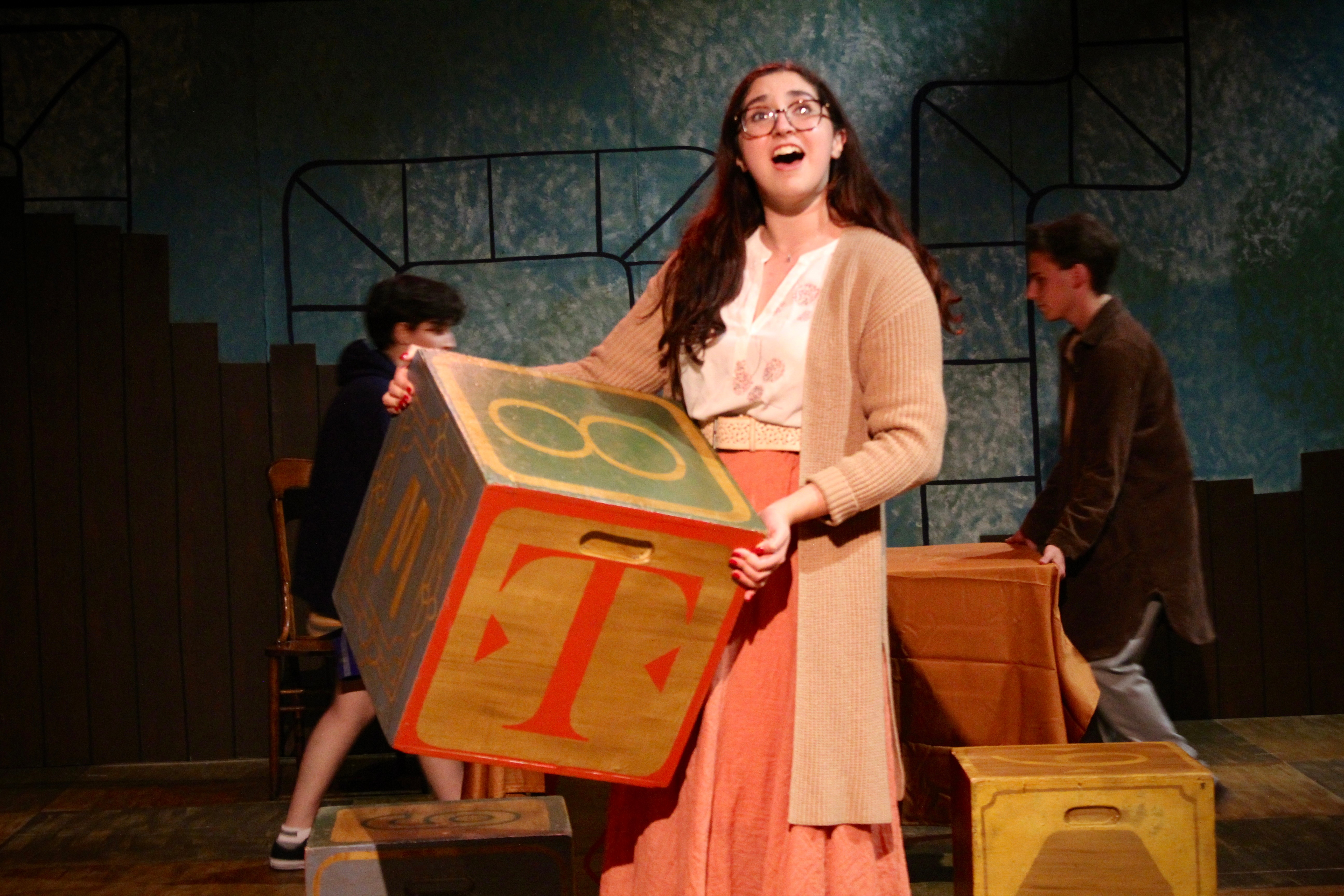 Falsettos - Trina with letter block scenic piece