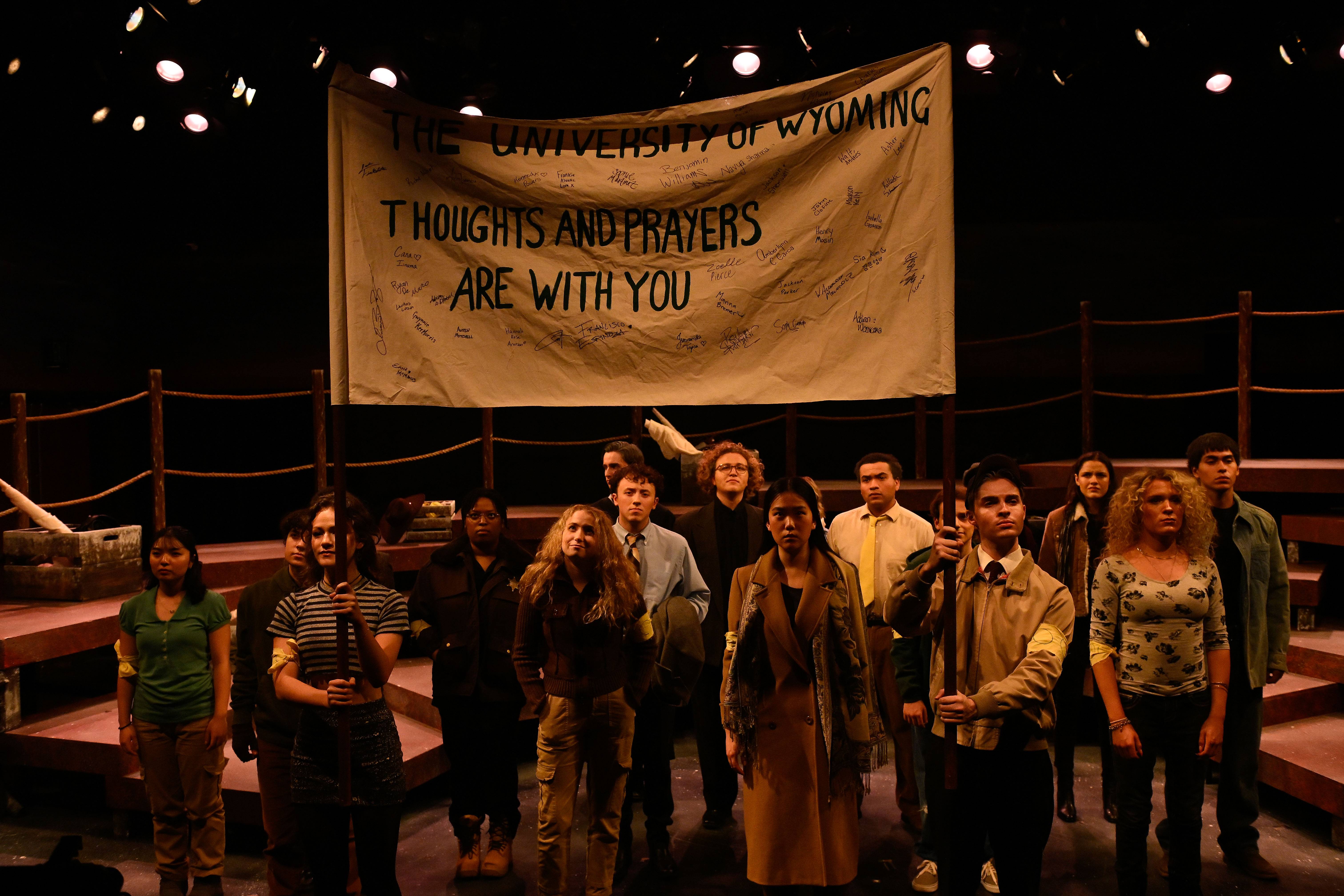 The Laramie Project - Ensemble under University of Wyoming Thoughts and Prayers banner