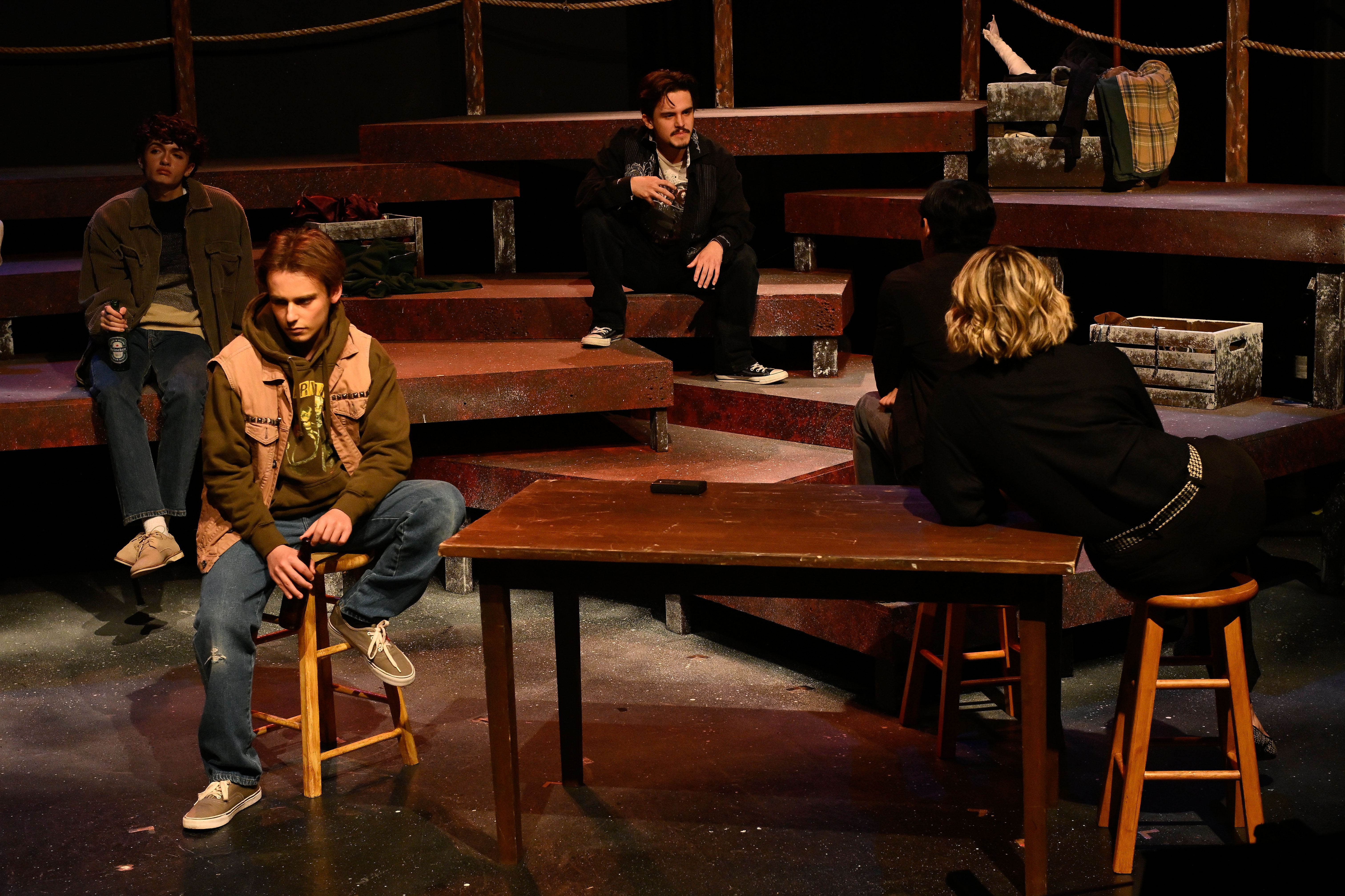 The Laramie Project - Bar scene with actors at wooden table