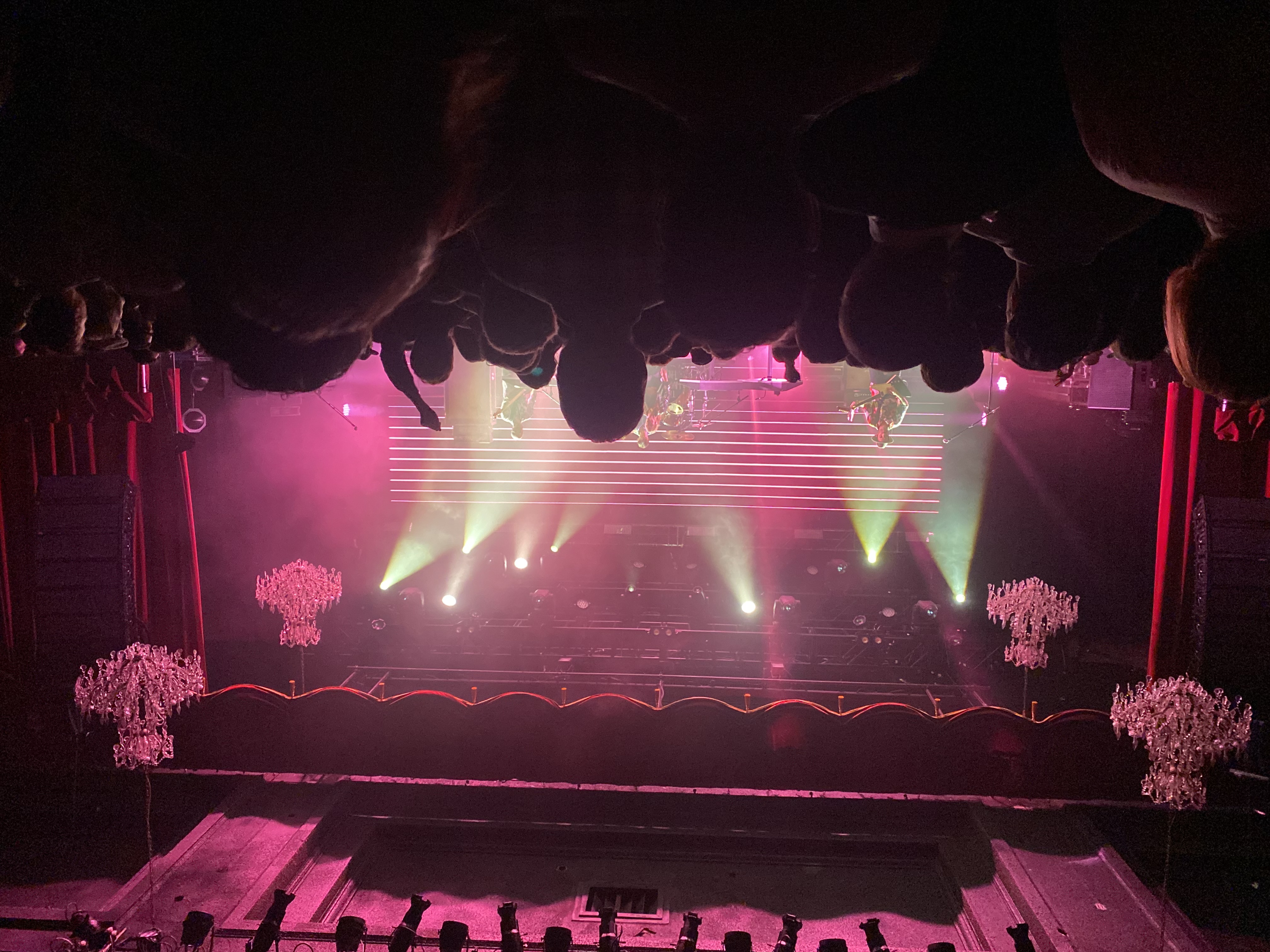Music - Live concert with pink and green stage lighting and chandeliers