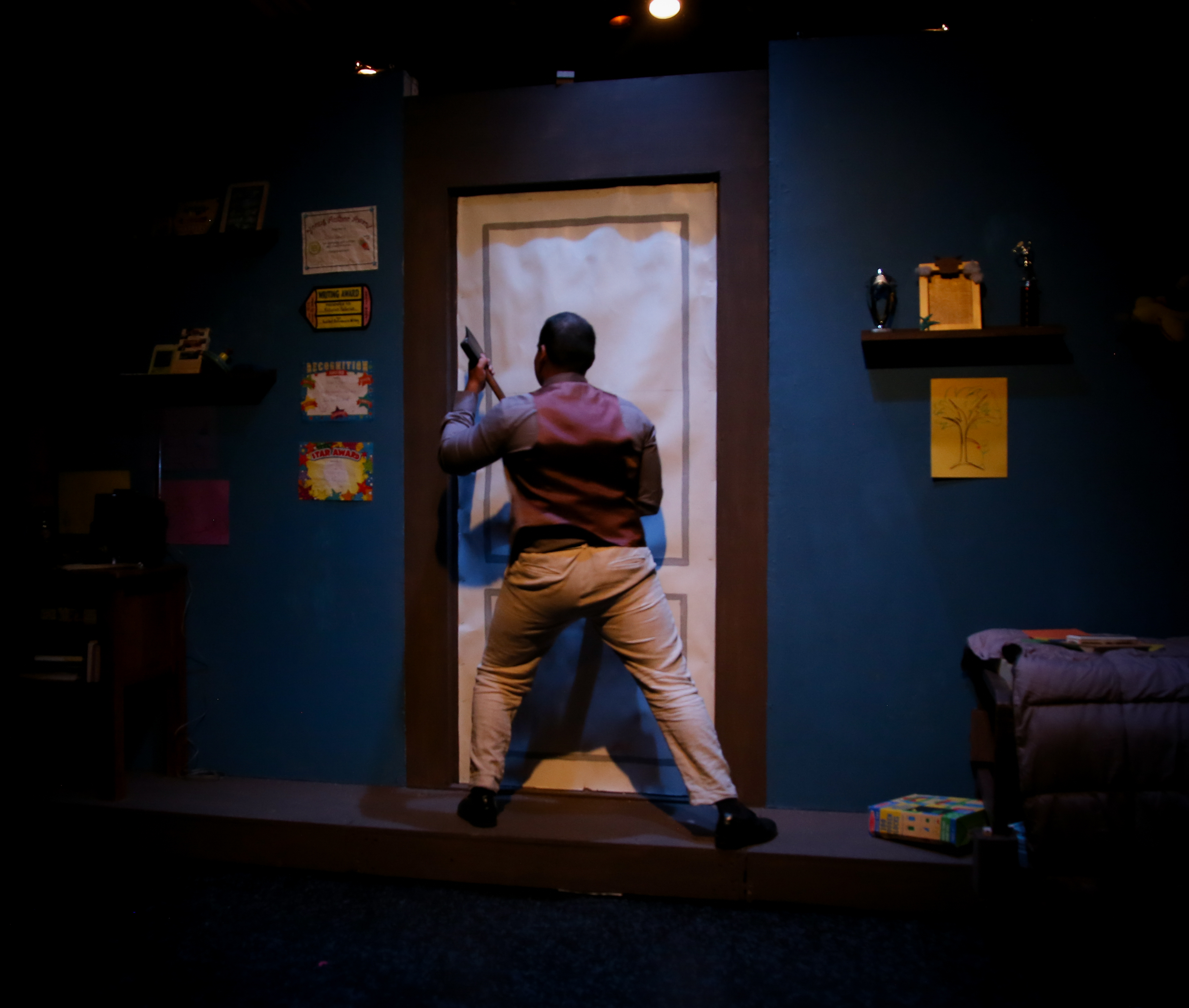 The Pillowman - Man with axe approaching paper door in blue bedroom