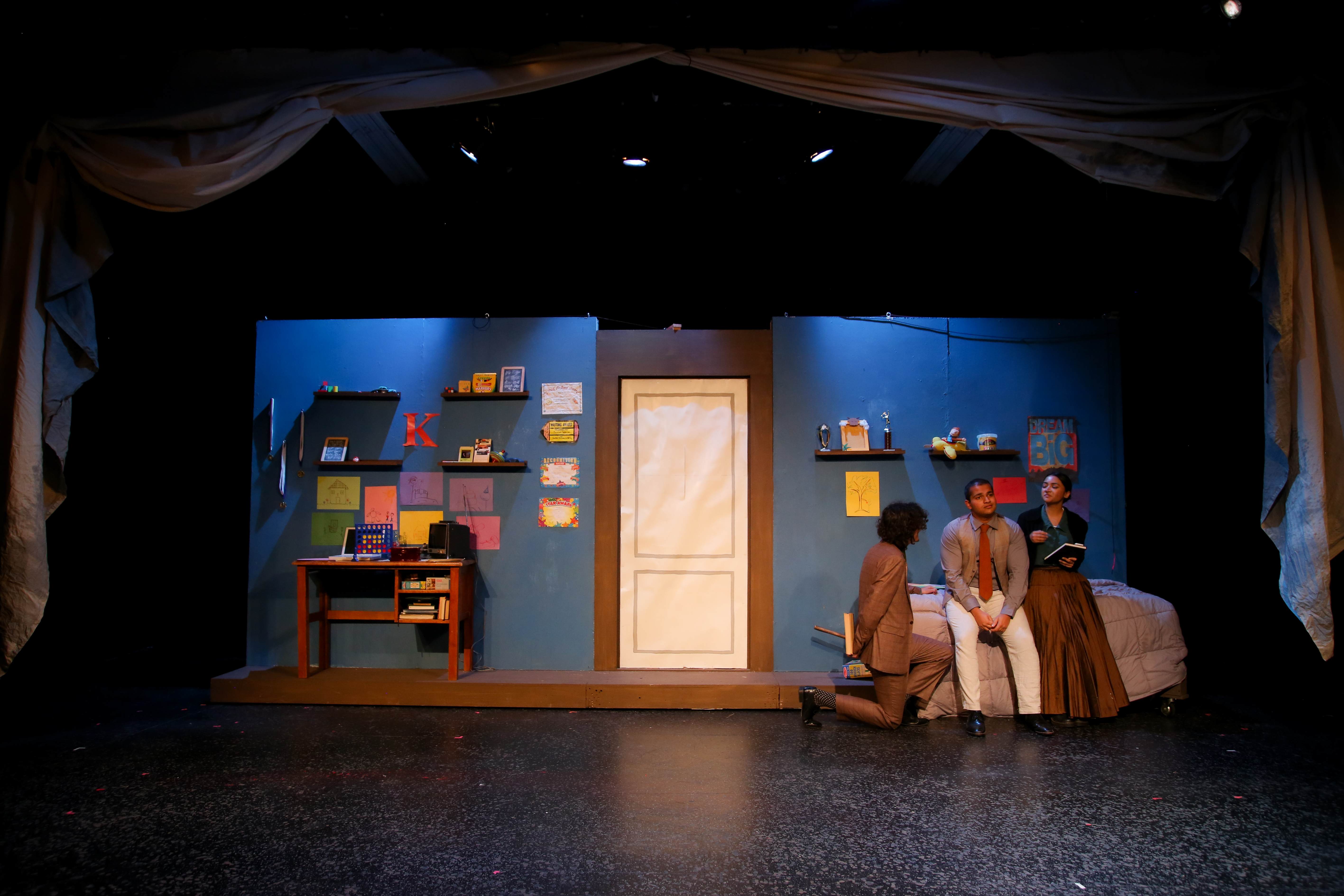 The Pillowman - Full blue bedroom set with colorful artwork and actors