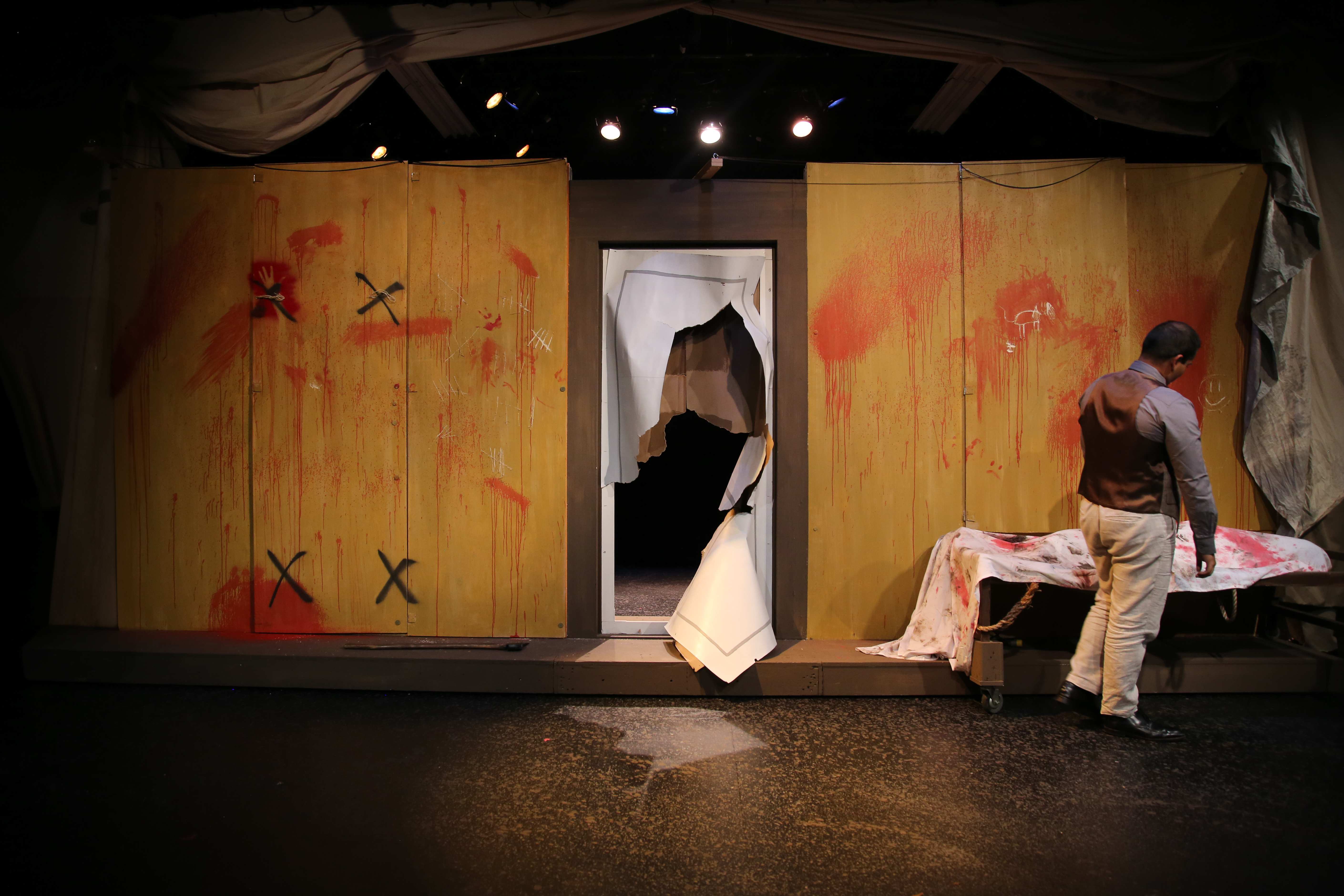 The Pillowman - Wide shot with blood-splattered set and gurney
