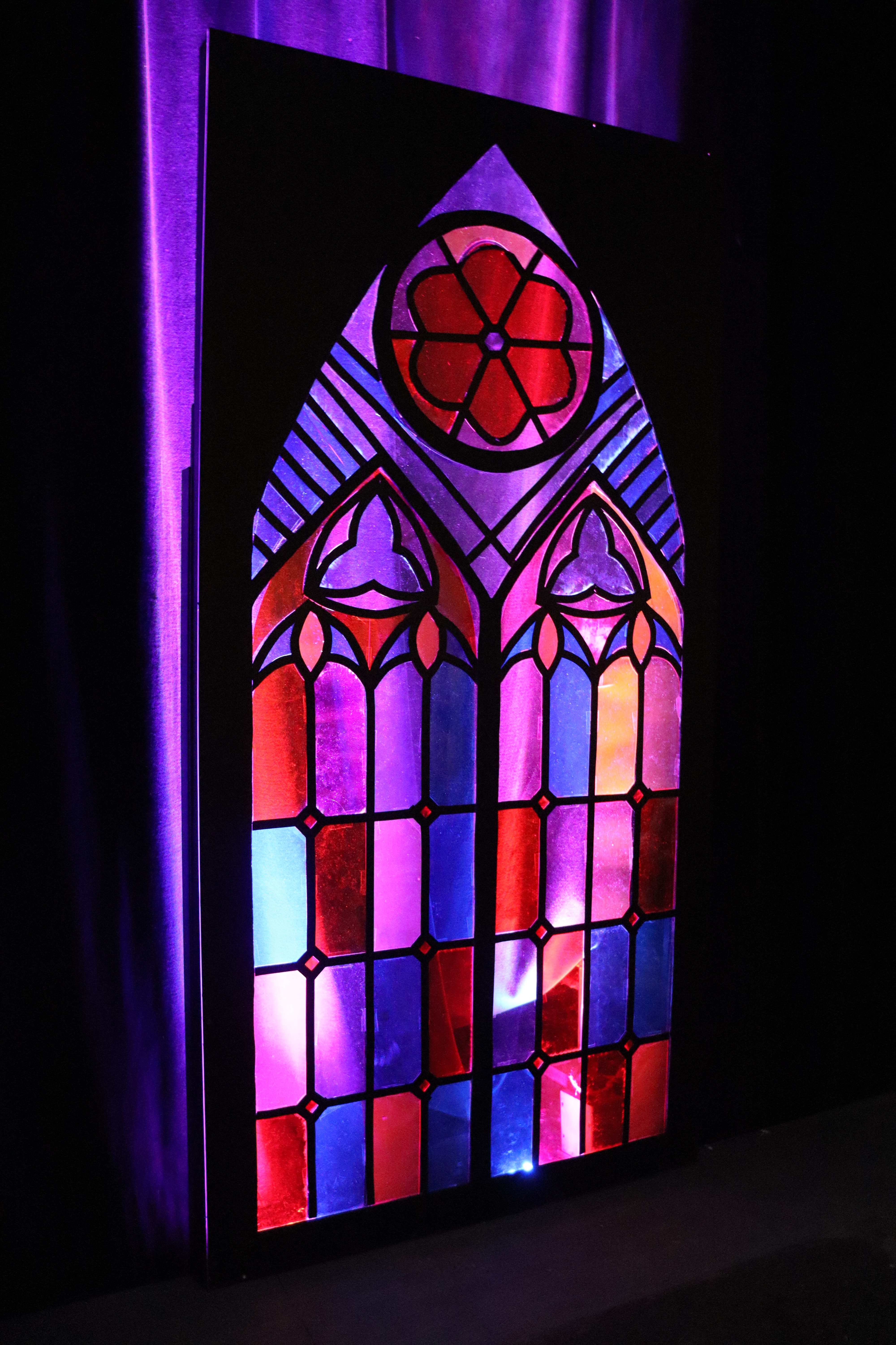 The Pillowman - Gothic stained glass window prop with purple and red light