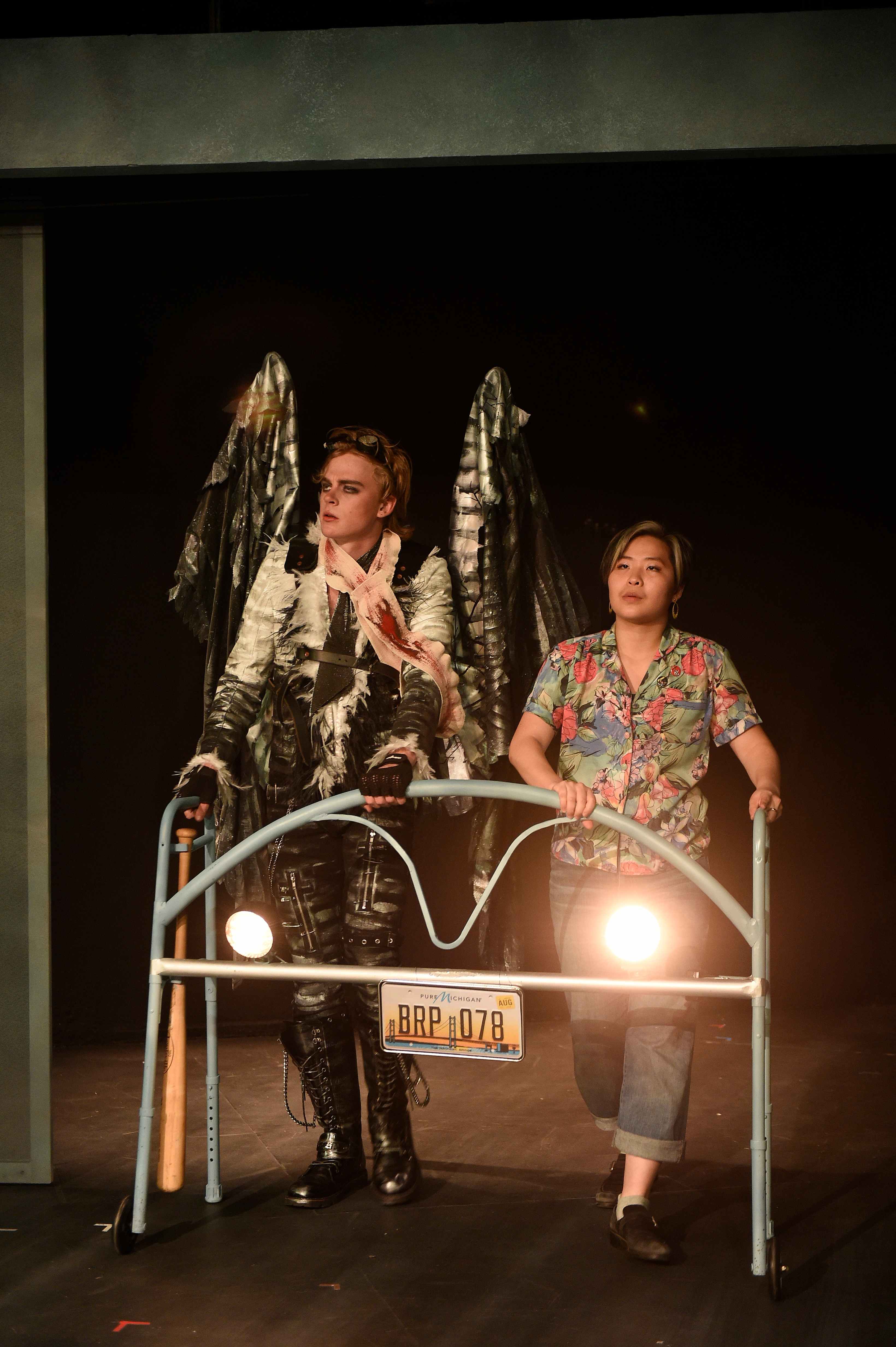 Somewhere Someone - Angel and woman behind lit cart with Michigan plate