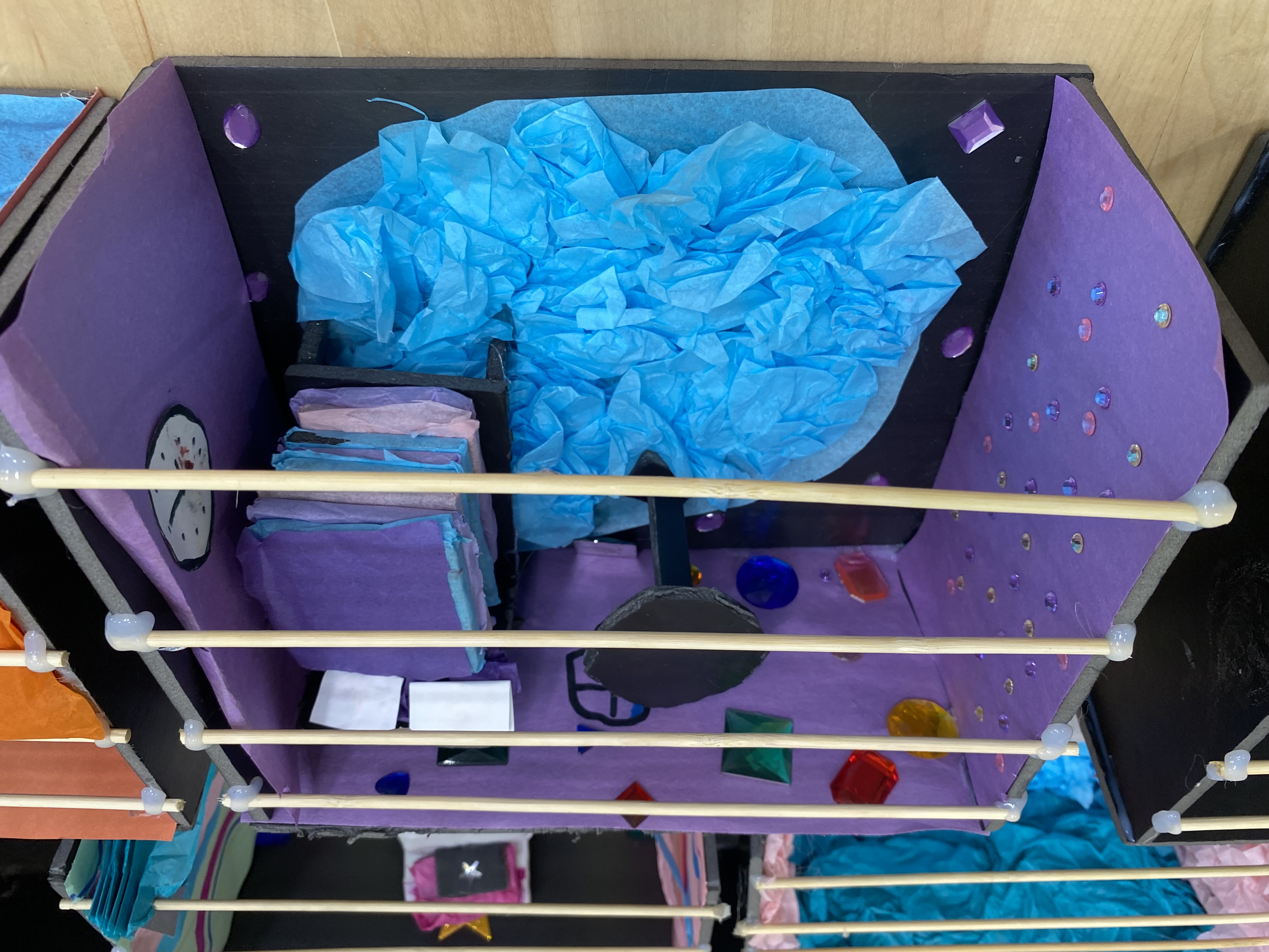 Teaching - Purple stage model with colorful gems, blue tissue paper pool, and furniture