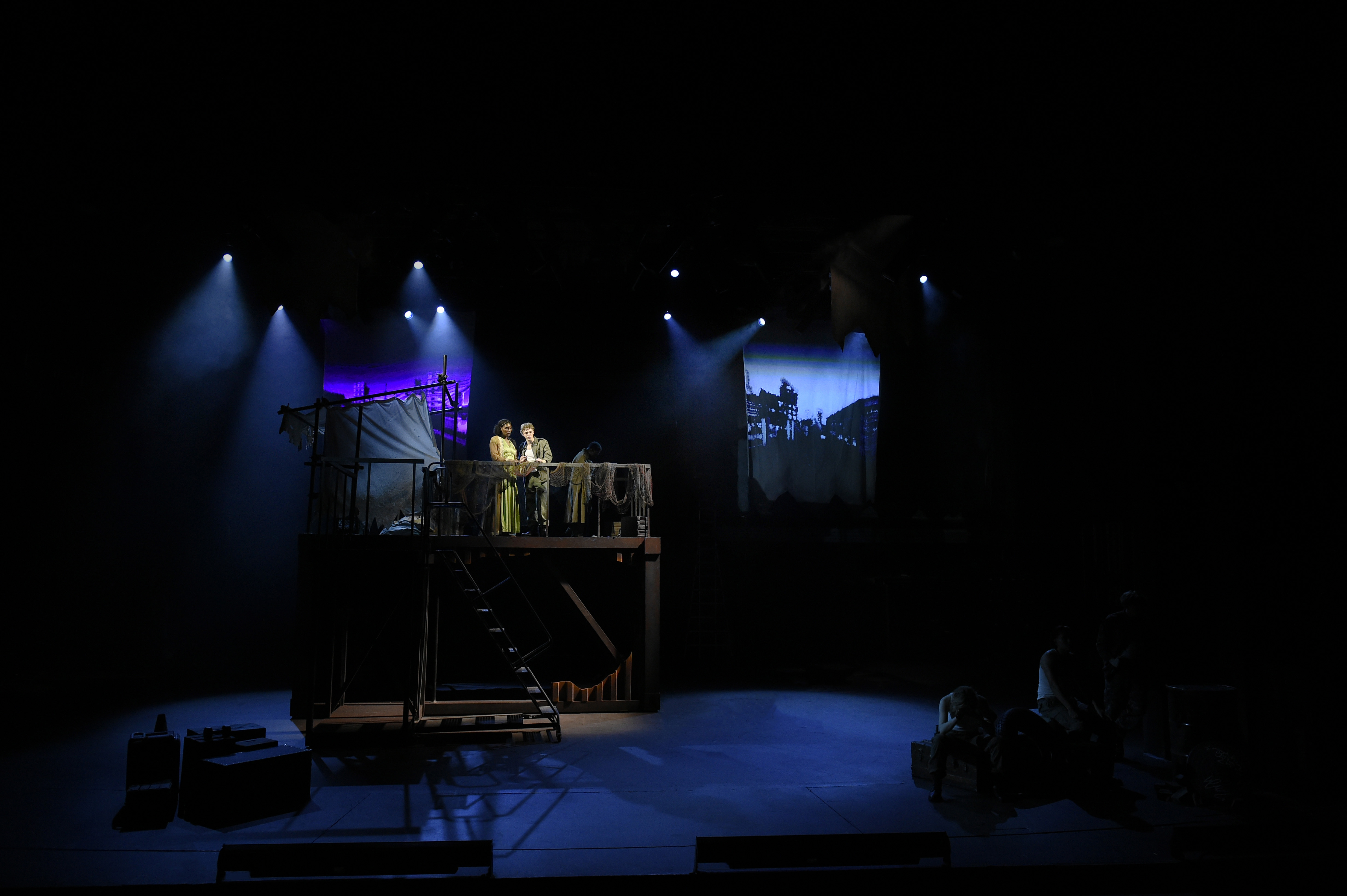 Troilus and Cressida - Blue-lit wide stage with elevated platform