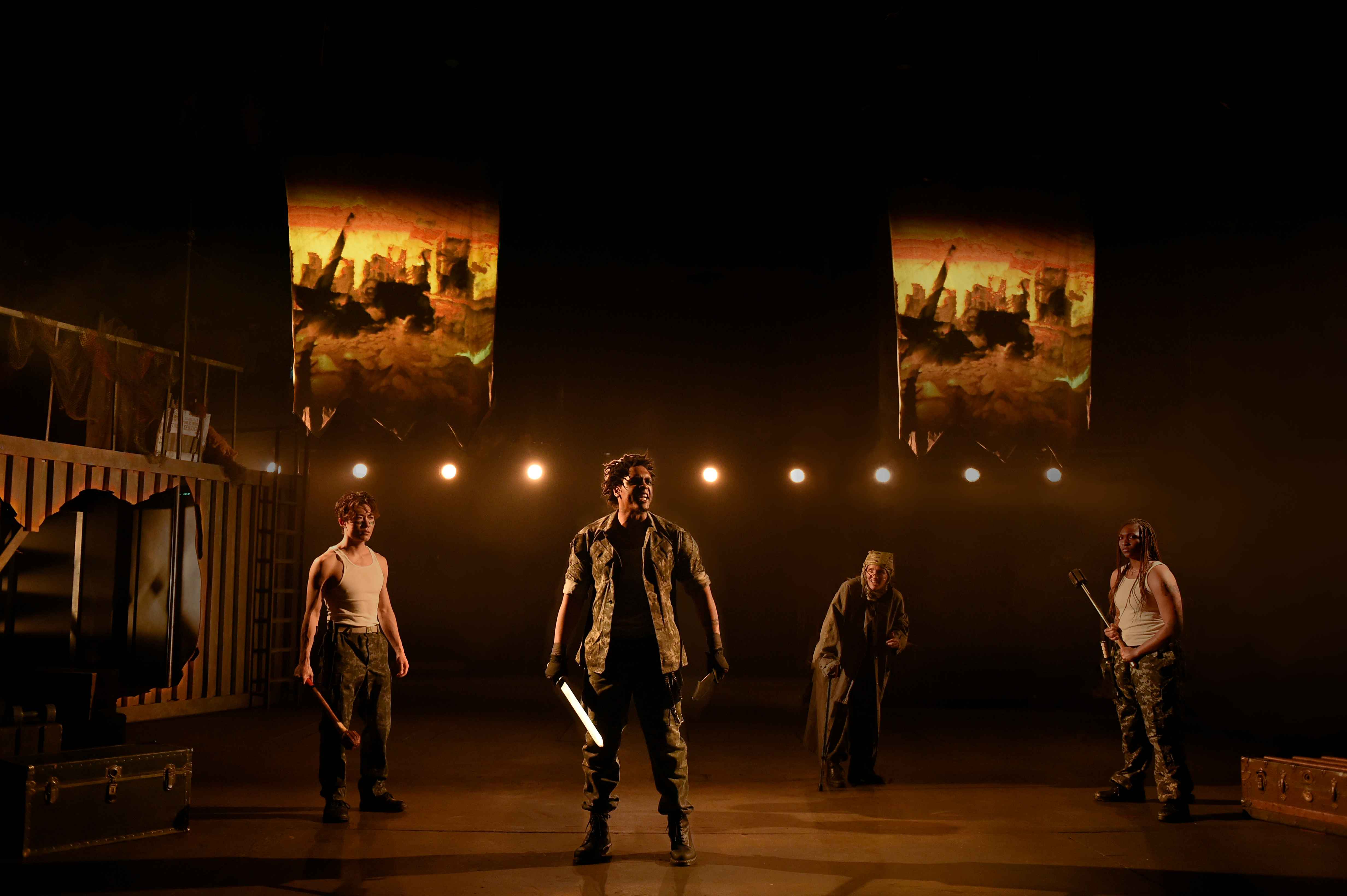 Troilus and Cressida - Warriors with painted banners under amber light