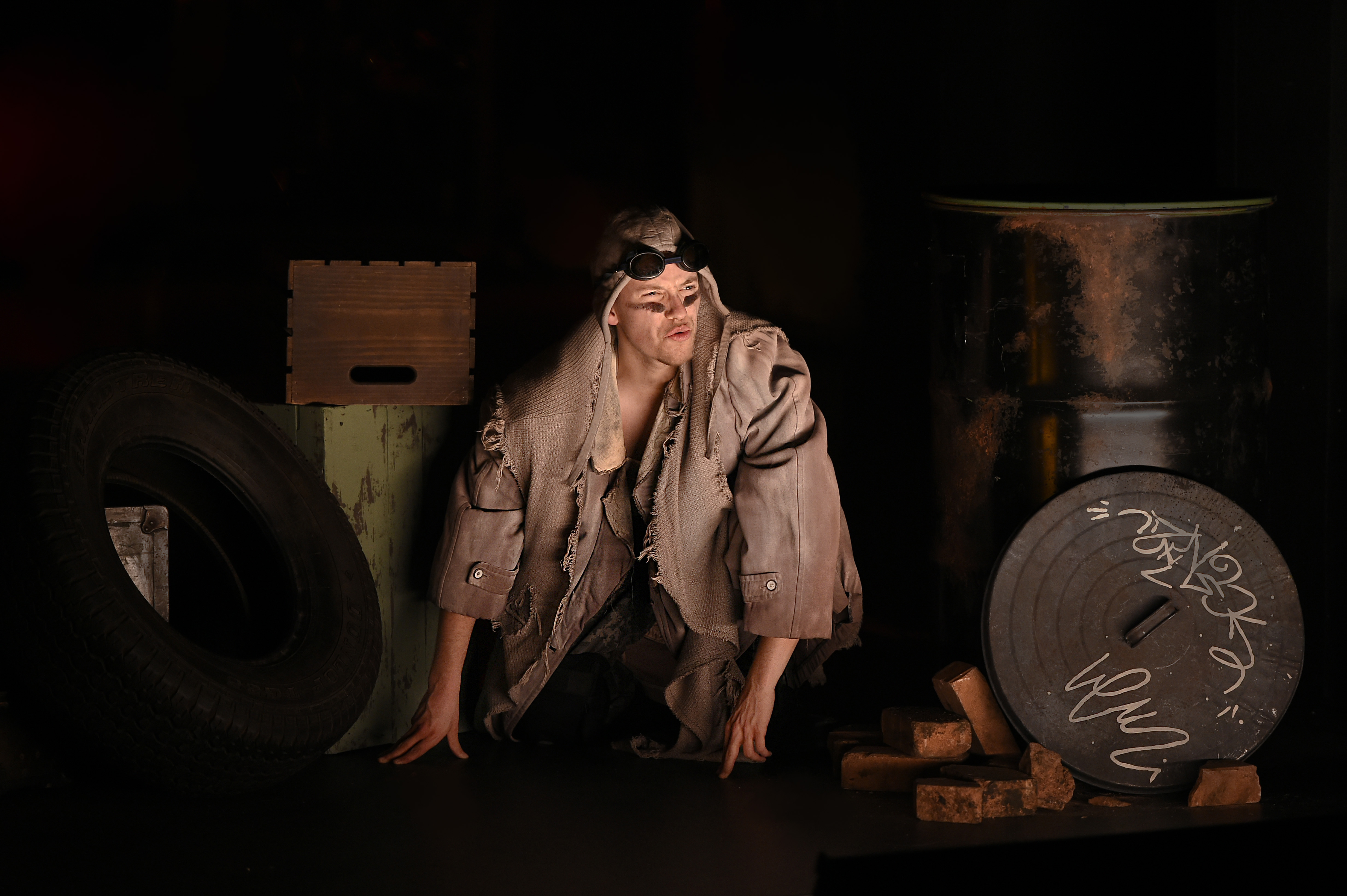 Troilus and Cressida - Thersites crouching among industrial debris