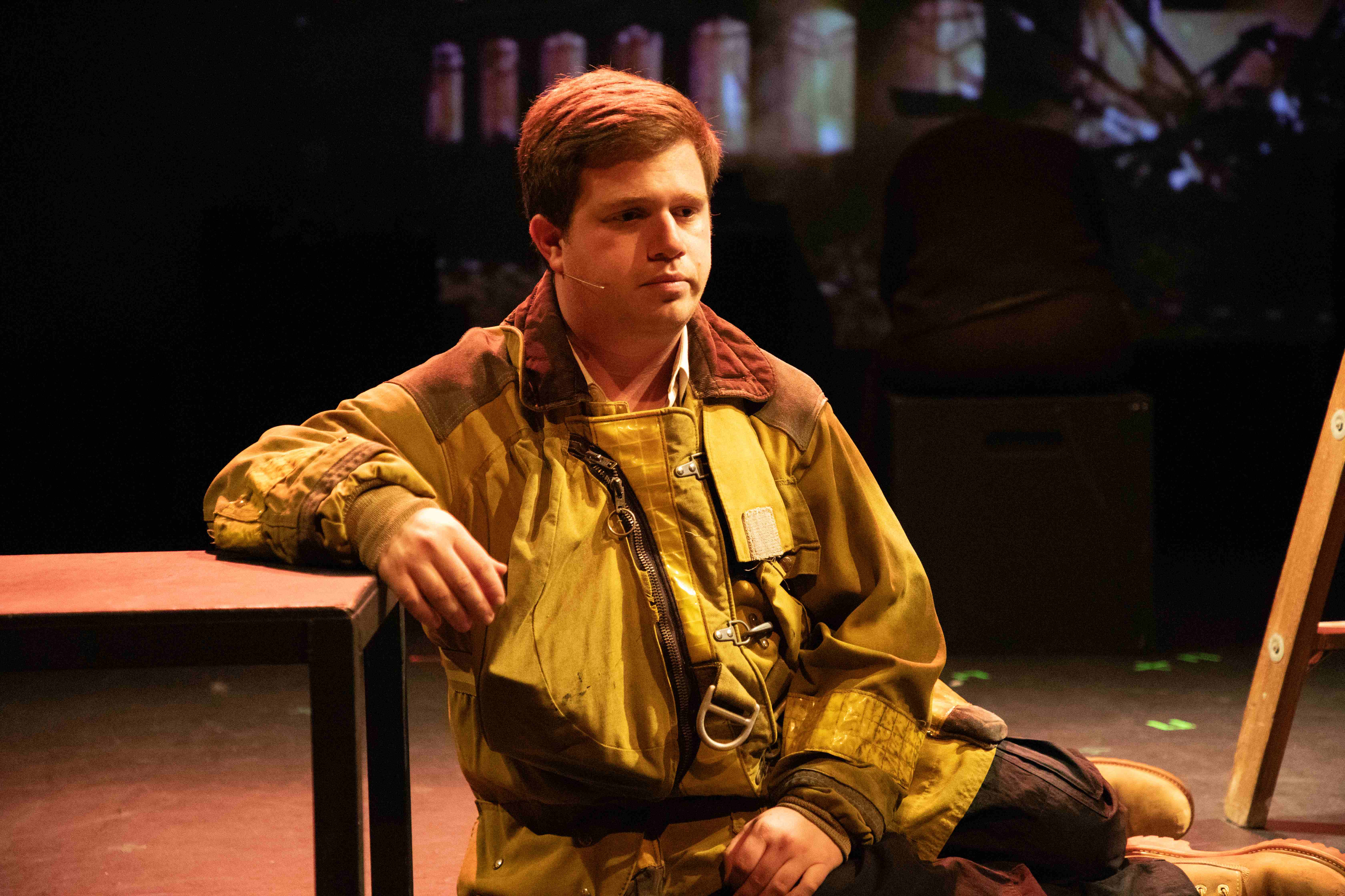 Working - Firefighter seated in yellow turnout gear