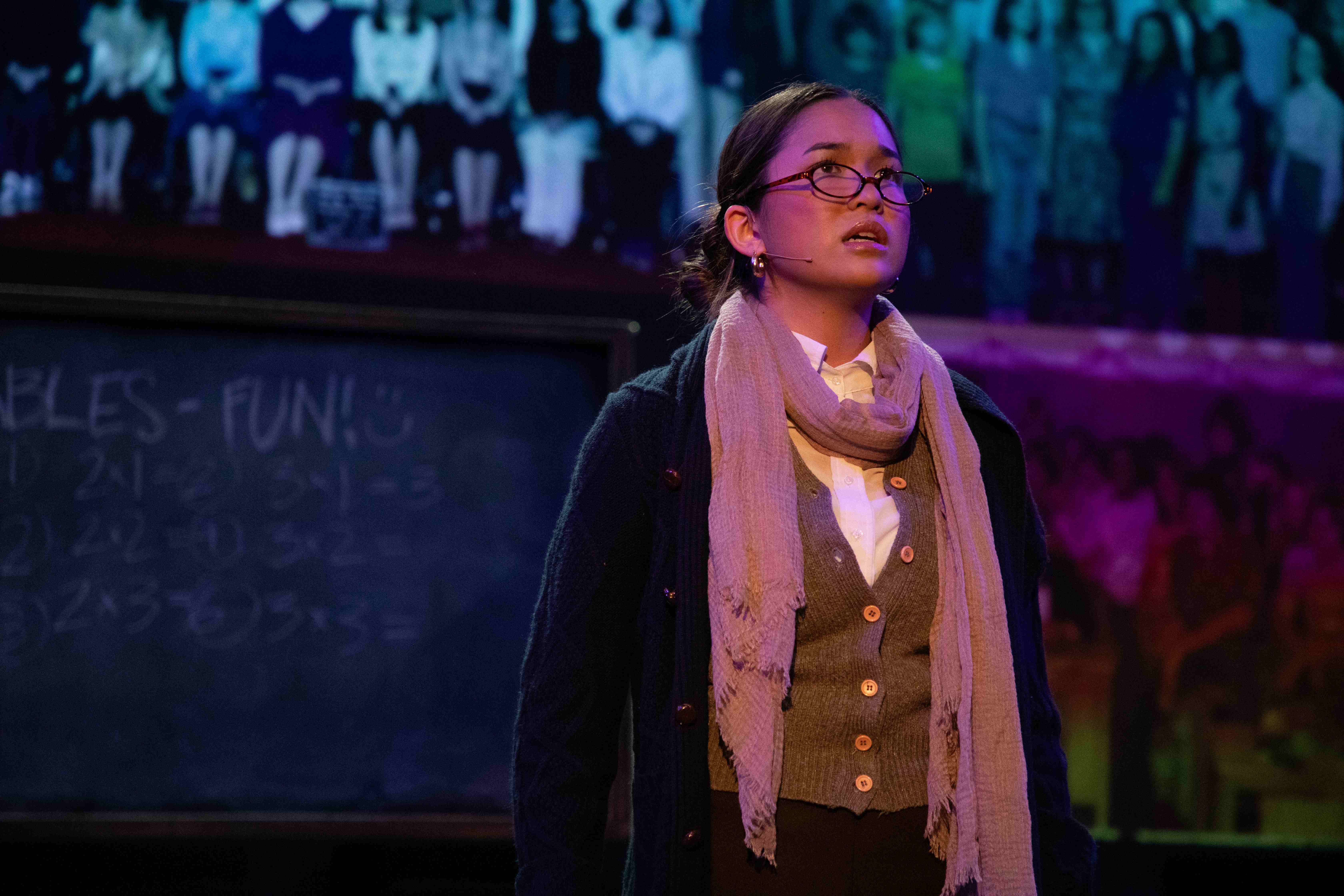 Working - Teacher in glasses and cardigan with chalkboard